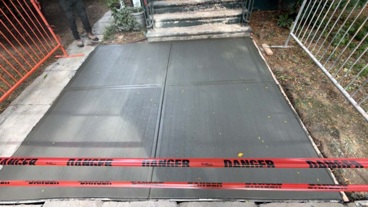New concrete walkway after DOT violation removal on Argyle Road, Brooklyn