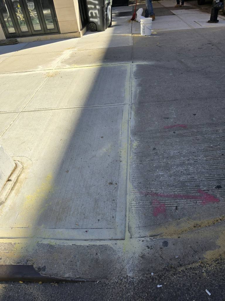 New sidewalk flags replaced to clear a DOT violation on Second Avenue, Yorkville, Manhattan