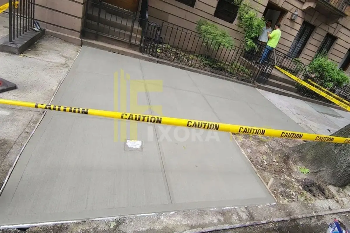 Concrete sidewalk in New York City illustrating sidewalk maintenance requirements for property owners
